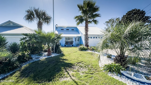 view of front of house with a front yard and a garage