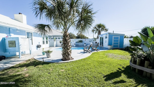 view of yard featuring a fenced in pool, a shed, and a patio area