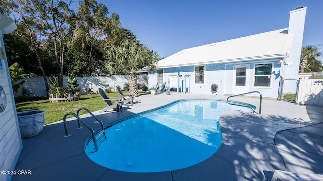 view of pool with a yard and a patio