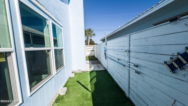 view of side of property with a lawn