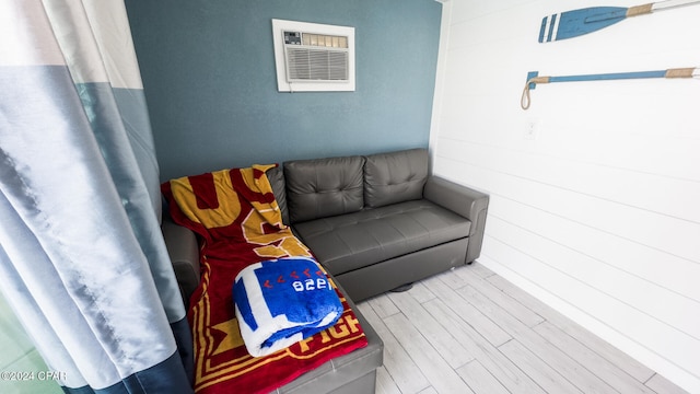 living room featuring a wall unit AC and hardwood / wood-style flooring