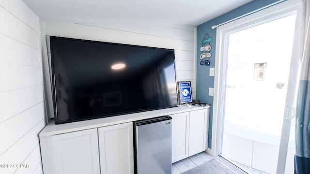 room details featuring stainless steel refrigerator and hardwood / wood-style flooring