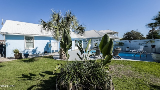 exterior space with a fenced in pool and a patio area