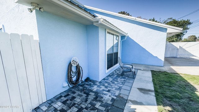 view of side of home with a patio area