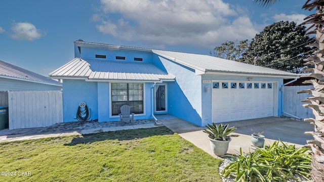 view of front of property featuring a front yard and a garage