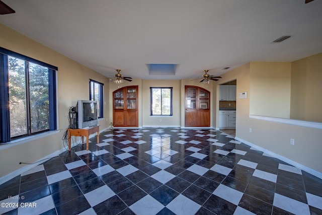 interior space with a wealth of natural light and ceiling fan