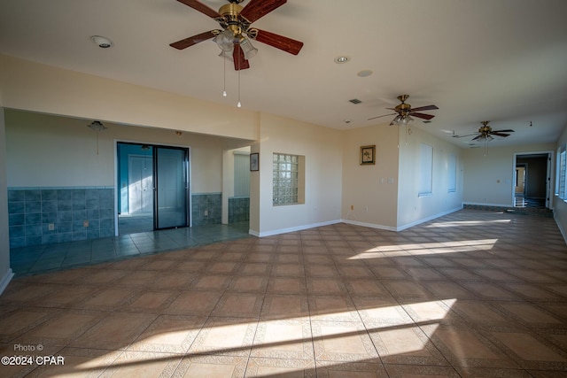 unfurnished room featuring elevator and tile patterned flooring