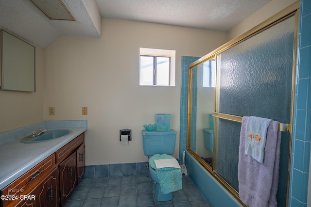 bathroom featuring combined bath / shower with glass door, a textured ceiling, and vanity