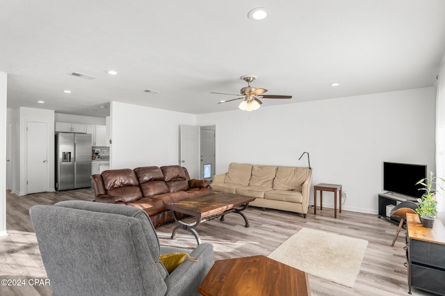 living room featuring ceiling fan and light hardwood / wood-style flooring