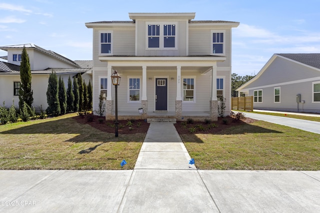 view of front of house with covered porch and a front yard