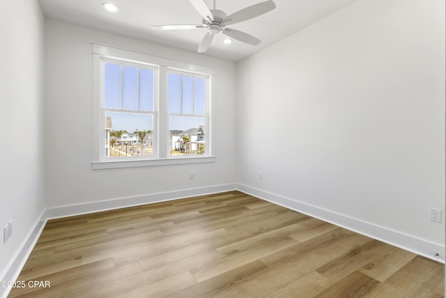 empty room featuring light wood-type flooring, ceiling fan, baseboards, and recessed lighting