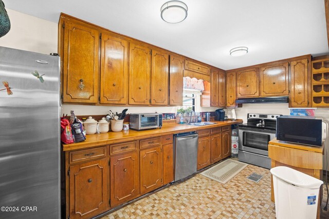 kitchen with sink and appliances with stainless steel finishes