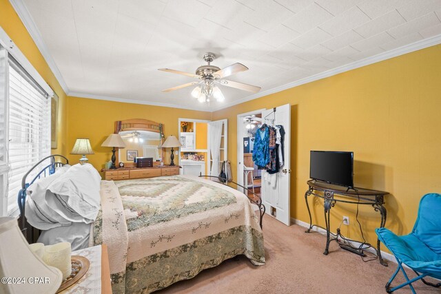 carpeted bedroom with ceiling fan, a closet, and ornamental molding