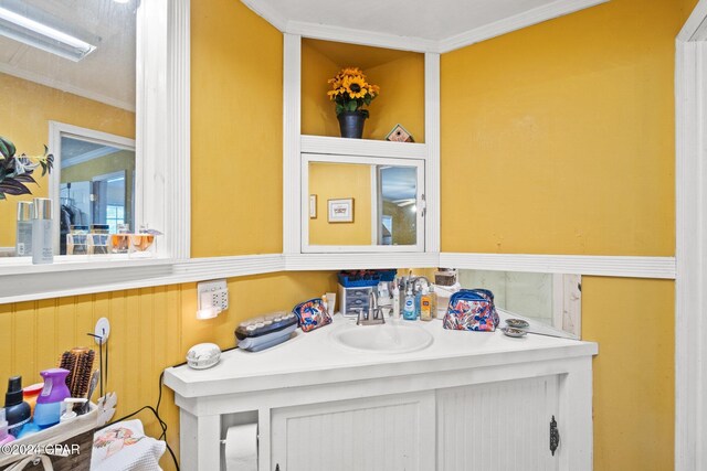 bathroom featuring crown molding and vanity