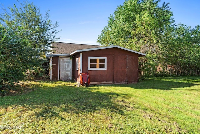 view of outbuilding with a yard