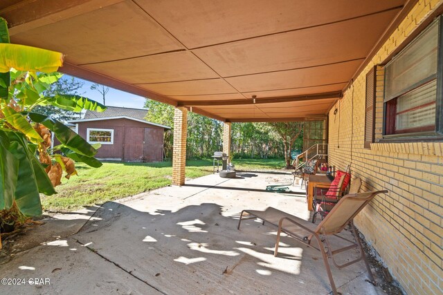 view of patio / terrace featuring a storage unit