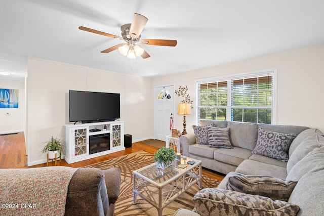 living room featuring hardwood / wood-style flooring and ceiling fan