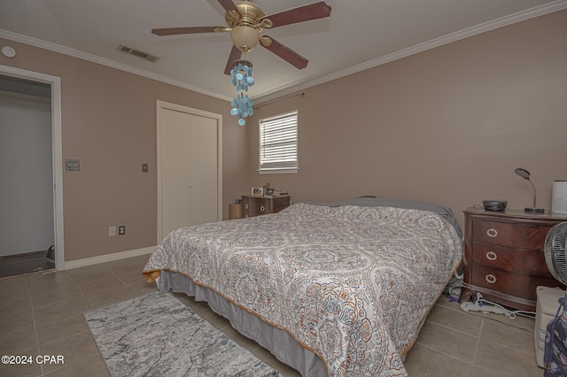 tiled bedroom with ceiling fan, a closet, and crown molding