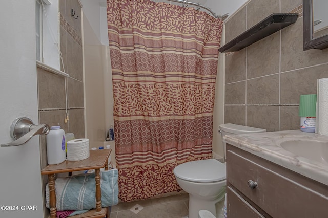 bathroom with tile patterned floors, toilet, tile walls, and vanity