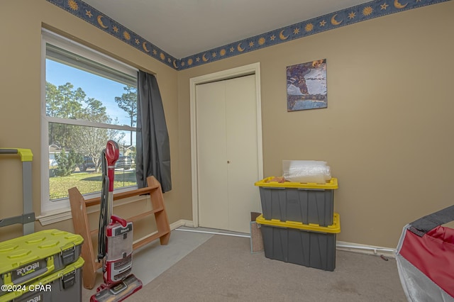 recreation room with light colored carpet