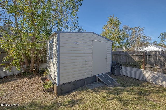 view of outbuilding featuring a lawn