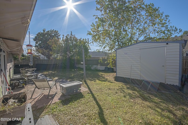 view of yard with a patio area and a storage shed