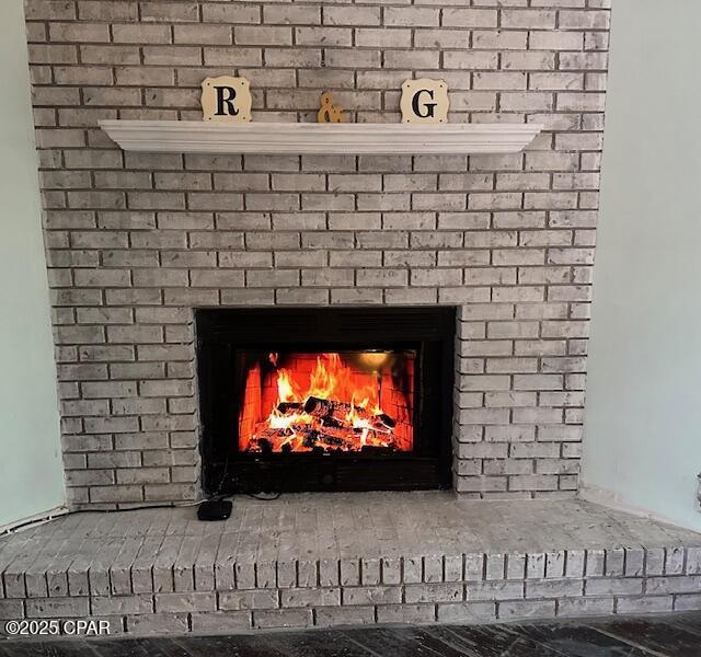 interior details with a brick fireplace