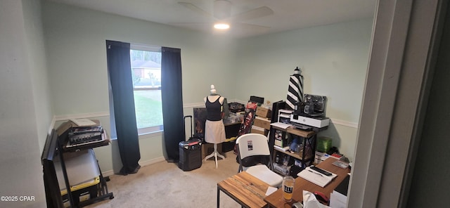 carpeted office space featuring ceiling fan