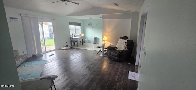 living area with hardwood / wood-style flooring, ceiling fan, and lofted ceiling