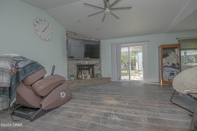 living room featuring hardwood / wood-style floors, vaulted ceiling, and ceiling fan