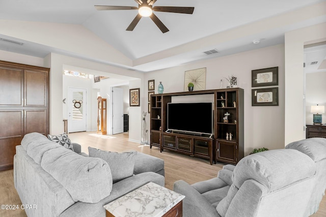 living room featuring light hardwood / wood-style floors, vaulted ceiling, and ceiling fan