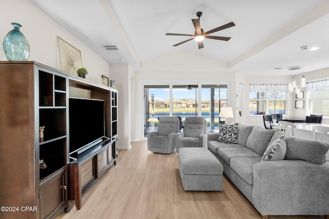 living room with ceiling fan, light hardwood / wood-style flooring, and vaulted ceiling