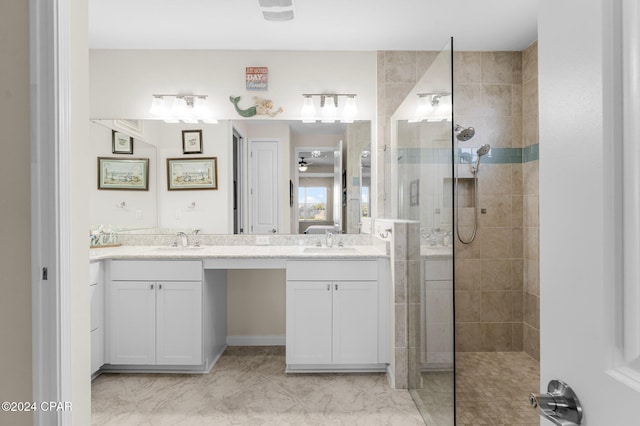 bathroom featuring a tile shower and vanity