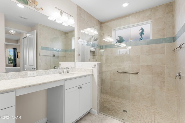 bathroom with vanity and a tile shower