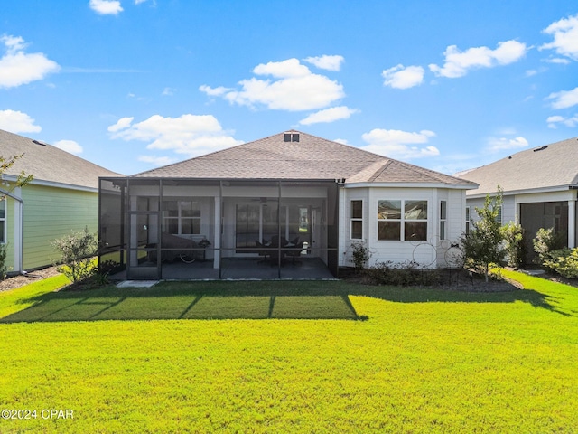 back of house featuring a sunroom, a yard, and a patio