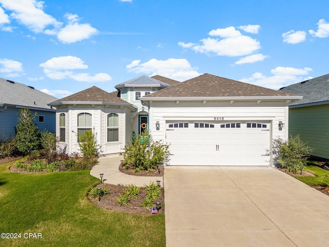 view of front of house with a front lawn and a garage