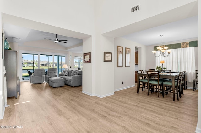 dining room featuring light hardwood / wood-style flooring and ceiling fan with notable chandelier