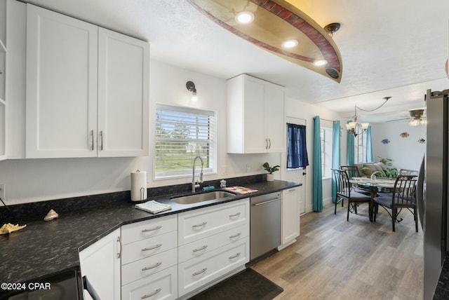 kitchen featuring white cabinets, stainless steel appliances, light hardwood / wood-style floors, and sink