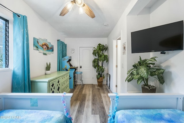 bedroom with ceiling fan and light hardwood / wood-style floors