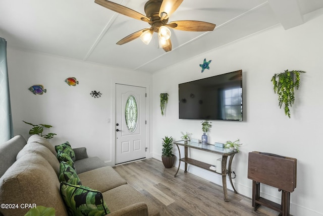 living room featuring beam ceiling, ceiling fan, and hardwood / wood-style floors