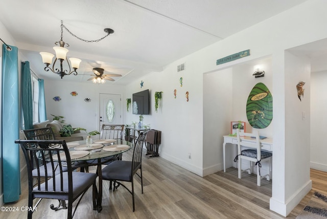 dining room with hardwood / wood-style floors, ceiling fan with notable chandelier, and plenty of natural light