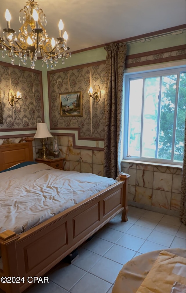 bedroom with a chandelier and light tile patterned flooring