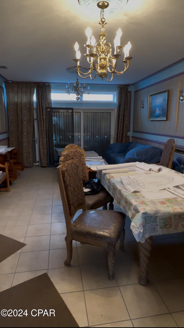 dining space with tile patterned floors and a notable chandelier