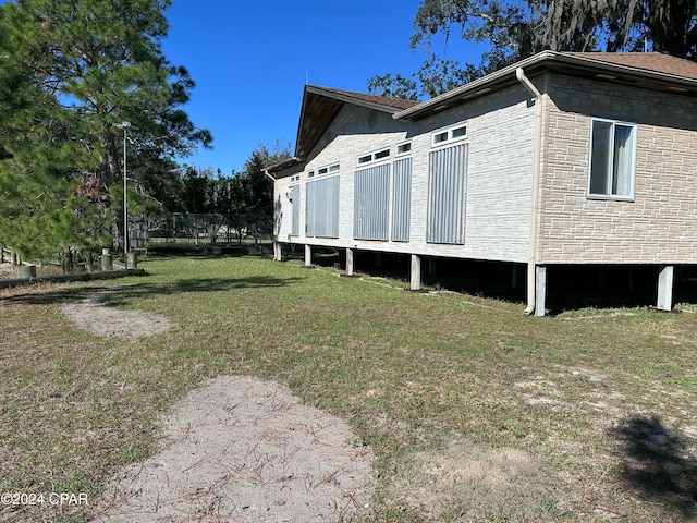 view of side of home with a lawn