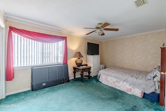 carpeted bedroom with ceiling fan, ornamental molding, and a textured ceiling