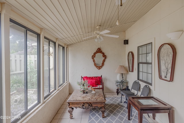 sunroom with plenty of natural light, ceiling fan, lofted ceiling, and wooden ceiling