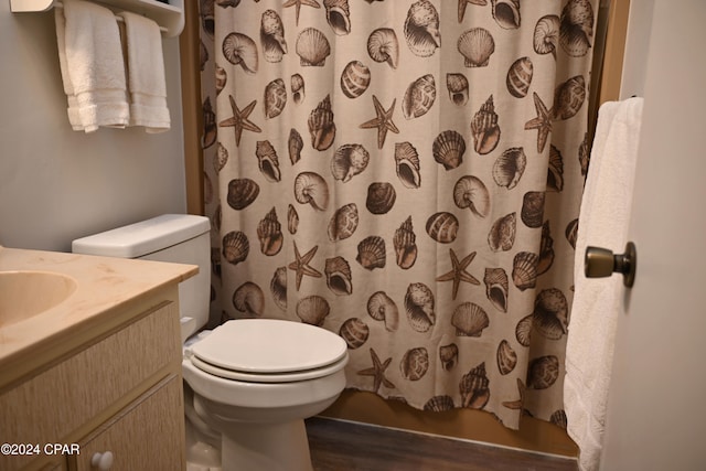 bathroom featuring vanity, hardwood / wood-style flooring, toilet, and curtained shower