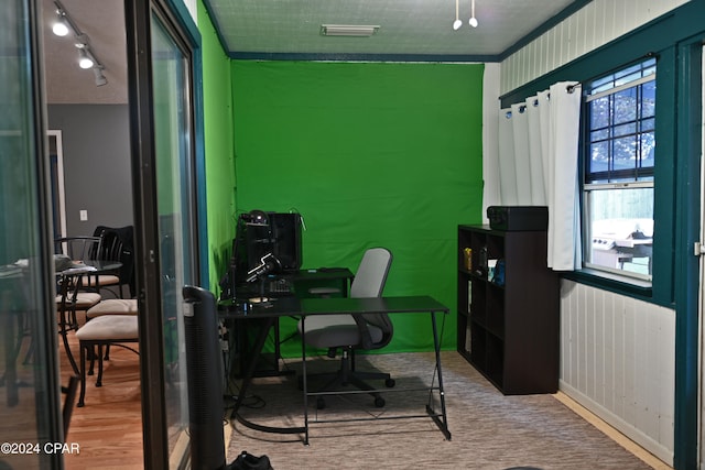 office featuring crown molding, a textured ceiling, and hardwood / wood-style flooring