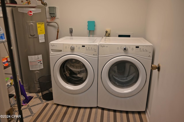 laundry area featuring washing machine and clothes dryer and electric water heater