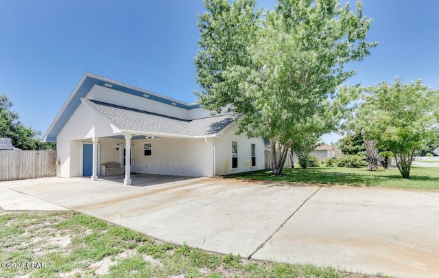 view of side of home featuring a carport